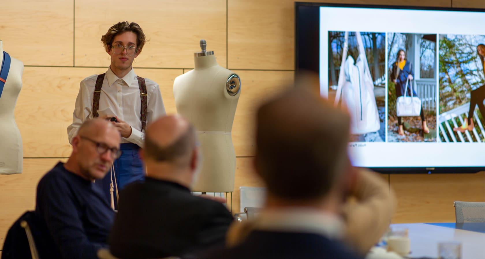 Fashion Design student presenting designs to industry partners.